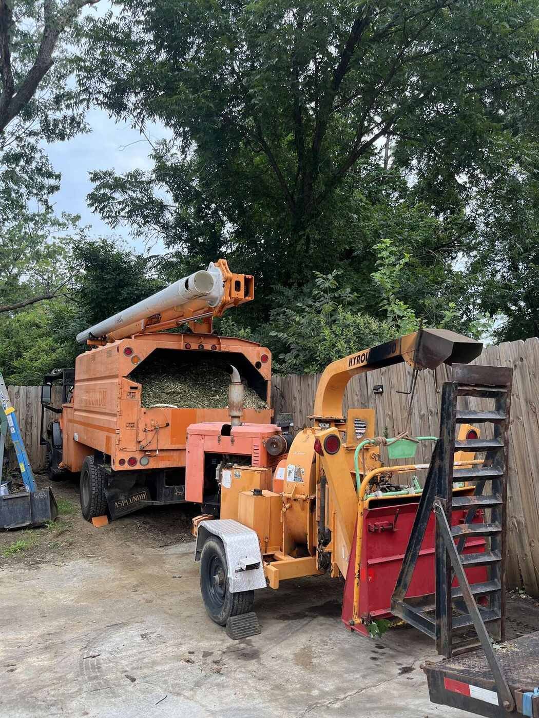 Green Limb chip truck and crew staged at a Greensboro job site