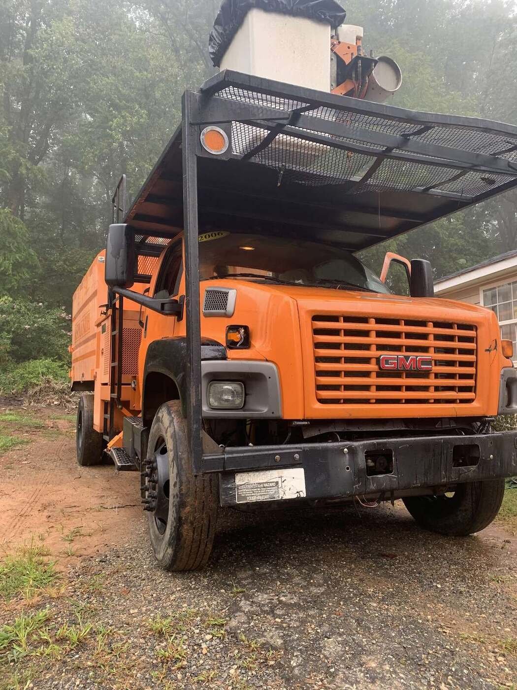 Green Limb chip truck and crew on a residential job site